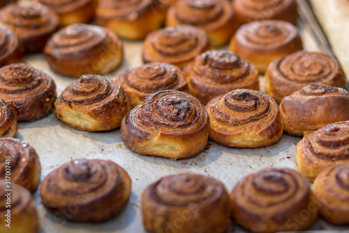 Roll cinnamon in a glaze of sugar syrup, baked, golden, and delicious.