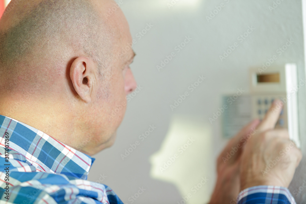 man takes the readings of the apartment electric meter man takes the readings of the apartment electric meter