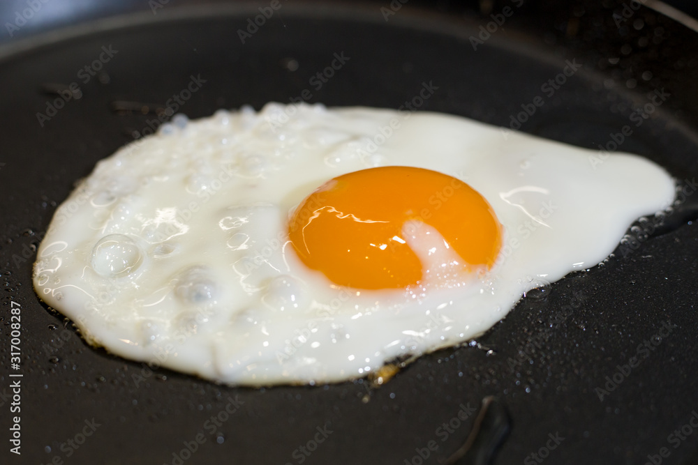 Scrambled eggs fried in a pan in the kitchen Scrambled eggs fried in a pan in the kitchen