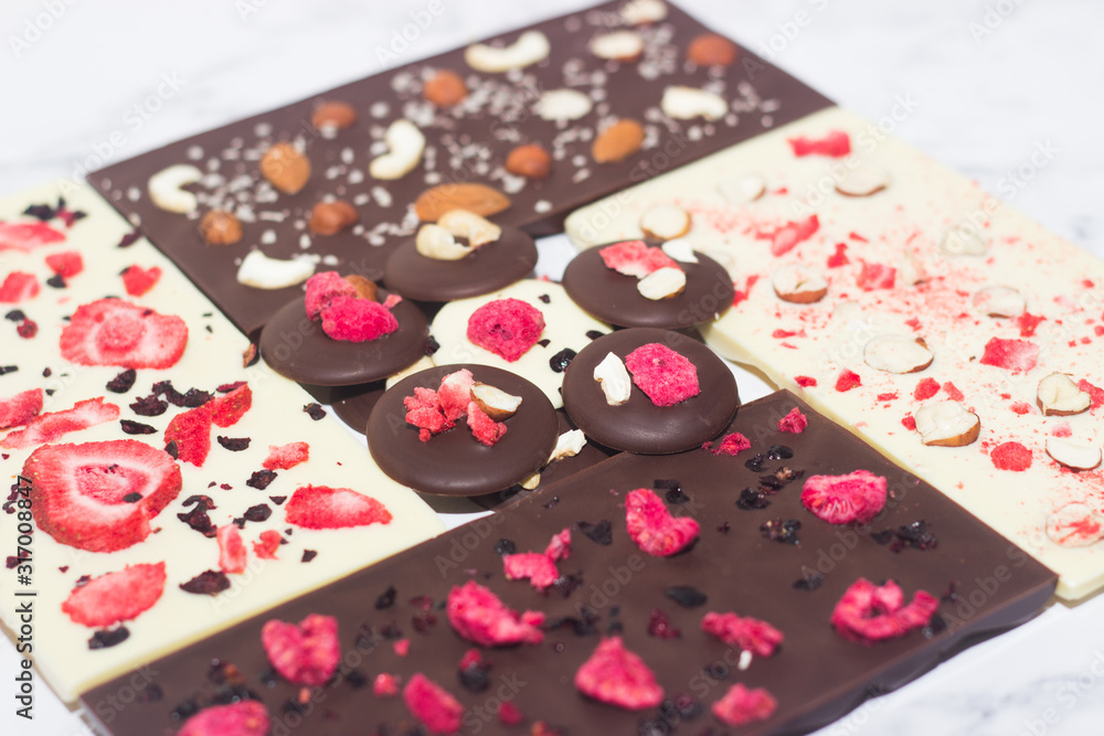 Homemade tasty chocolate on the table. Chocolate with fruits, berries and nuts. Homemade tasty chocolate on the table. Chocolate with fruits, berries and nuts.