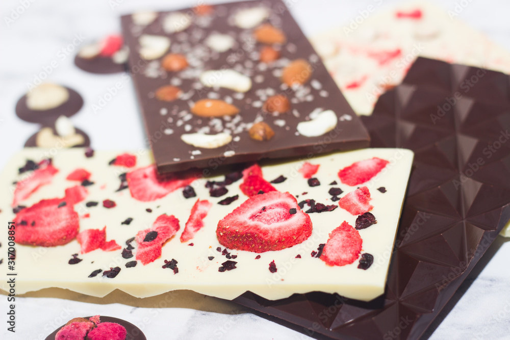 Homemade tasty chocolate on the table. Chocolate with fruits, berries and nuts. Homemade tasty chocolate on the table. Chocolate with fruits, berries and nuts.