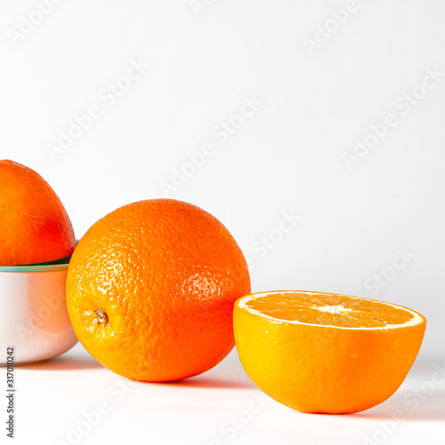 A cut juicy orange lies on a white background before cooking orange juice photo