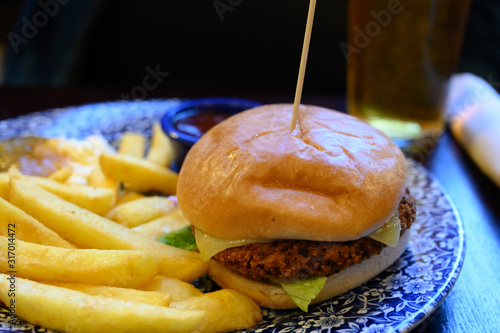 Veggy burger served with fried potato and hot chuthey sauce photo