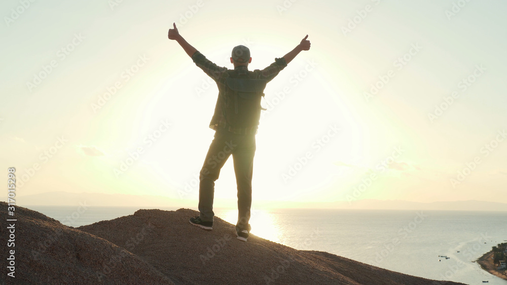 Senior traveler raise his hands in success gesture at sunrise Senior traveler raise his hands in success gesture at sunrise