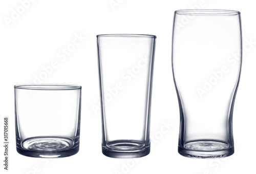 several glasses for drinks of different shapes and sizes isolated on a white background