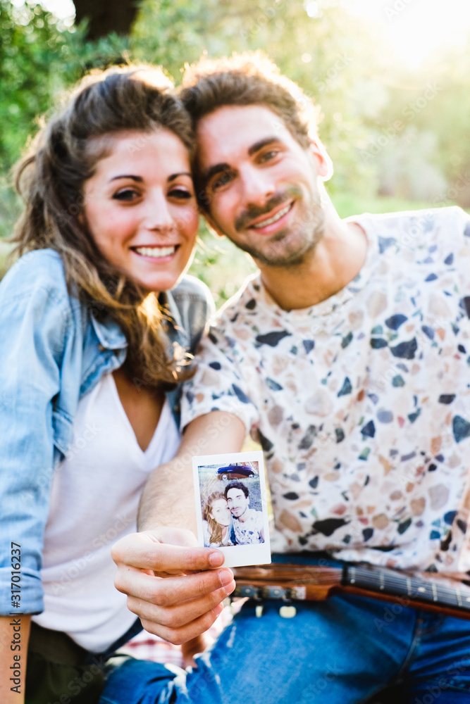 Beautiful couple taking a selfie having a picnic Beautiful couple taking a selfie having a picnic