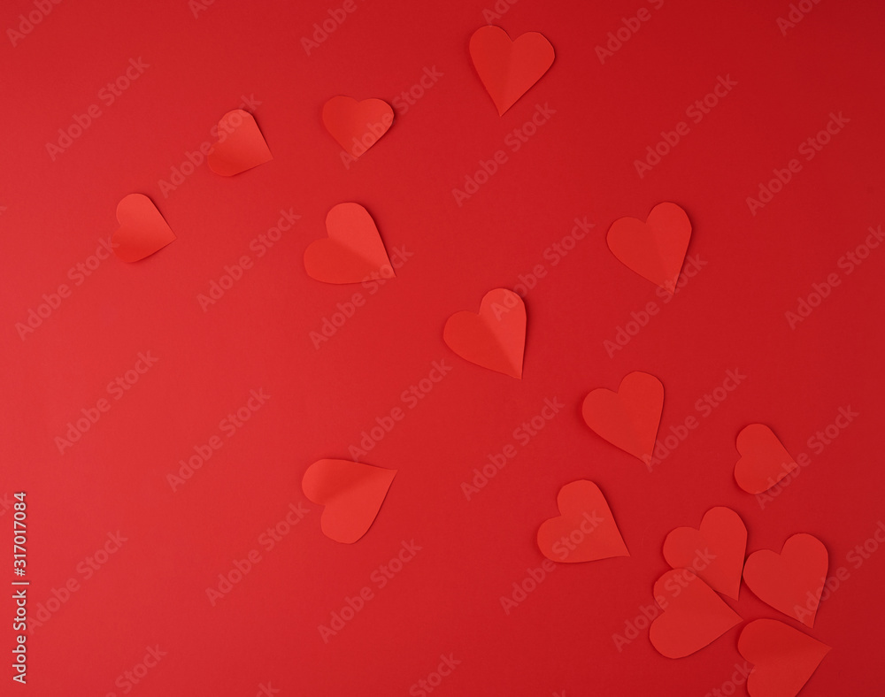 hearts cut out of red paper on a red background, festive backdrop for Valentine's Day
