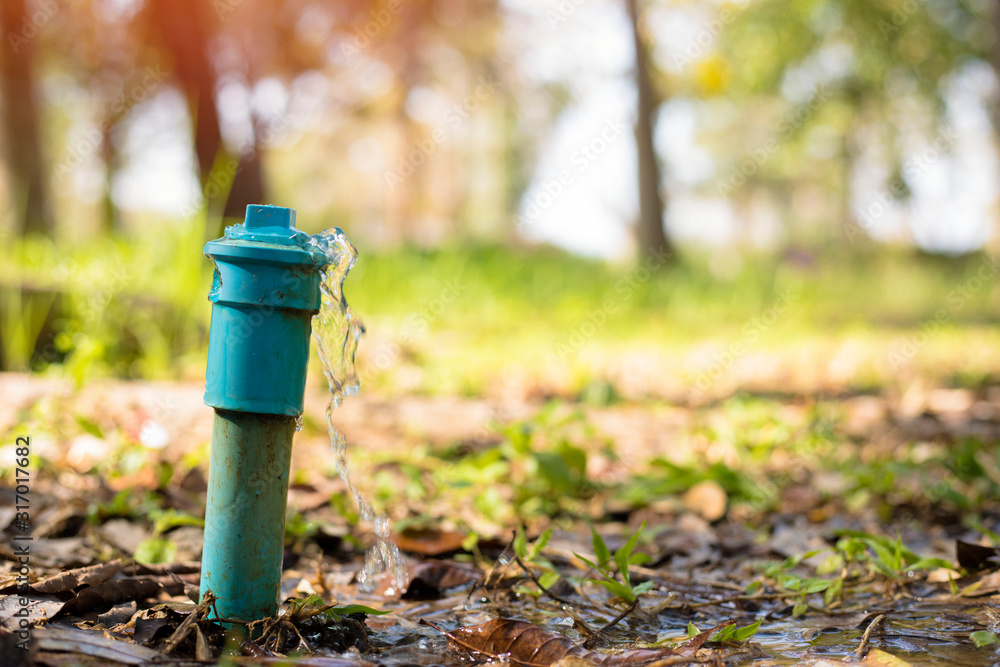 Wasting water,Leaking water pipe, water leaking drop in the garden Wasting water,Leaking water pipe, water leaking drop in the garden