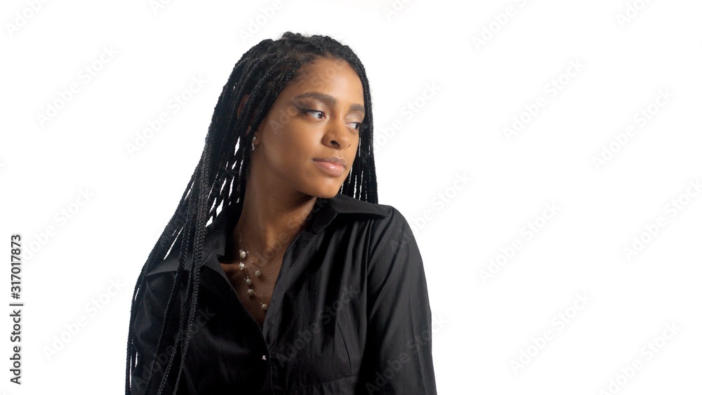 Closeup portrait of mixed race black woman with hair braids watching aside