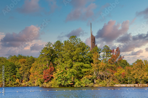A carillon beside a lake in the pine trees