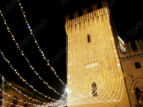 Ferrara, Italy. Victory Tower illuminated with Christmas lights.