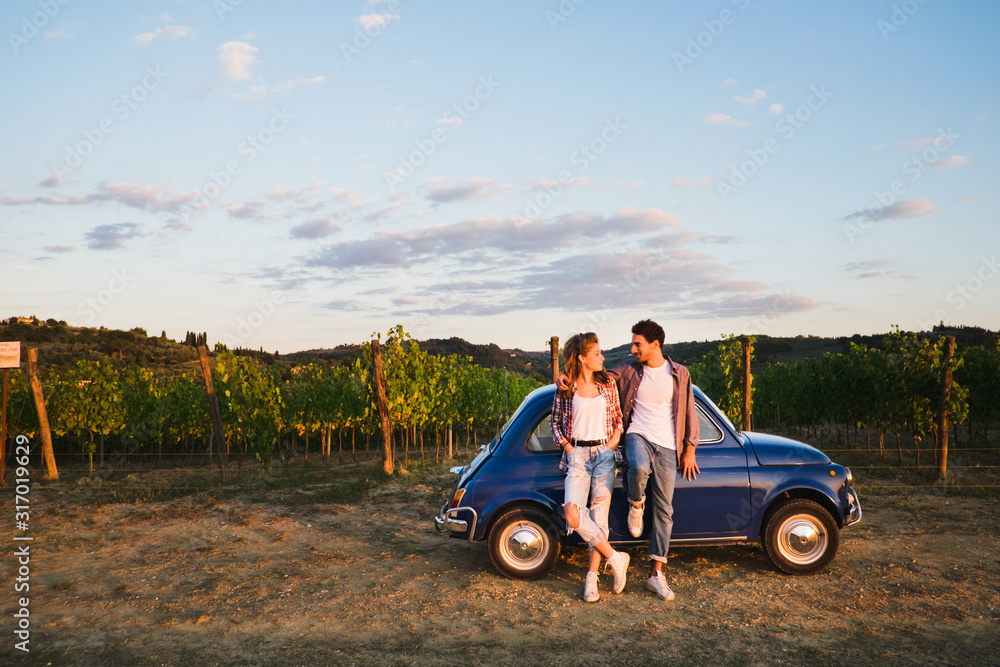 Beautiful couple trip in the country with a vintage car Beautiful couple trip in the country with a vintage car