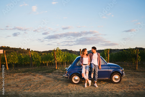 Beautiful couple trip in the country with a vintage car