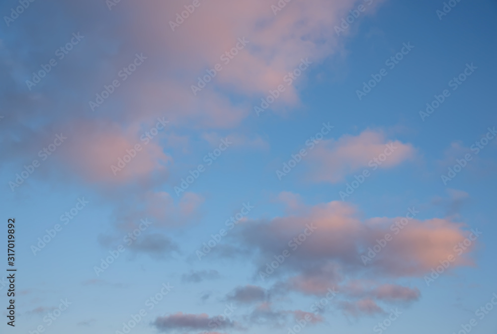 Pink vanilla clouds on a blue sunset sky. Pink vanilla clouds on a blue sunset sky.