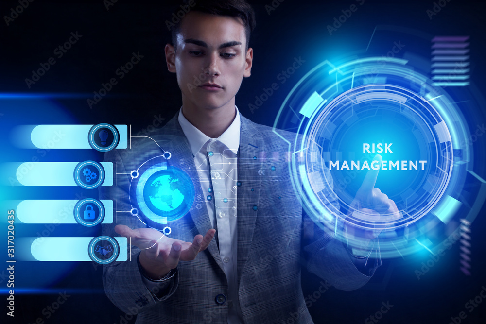 Business, Technology, Internet and network concept. Young businessman working on a virtual screen of the future and sees the inscription: Business, Technology, Internet and network concept. Young businessman working on a virtual screen of the future and sees the inscription: