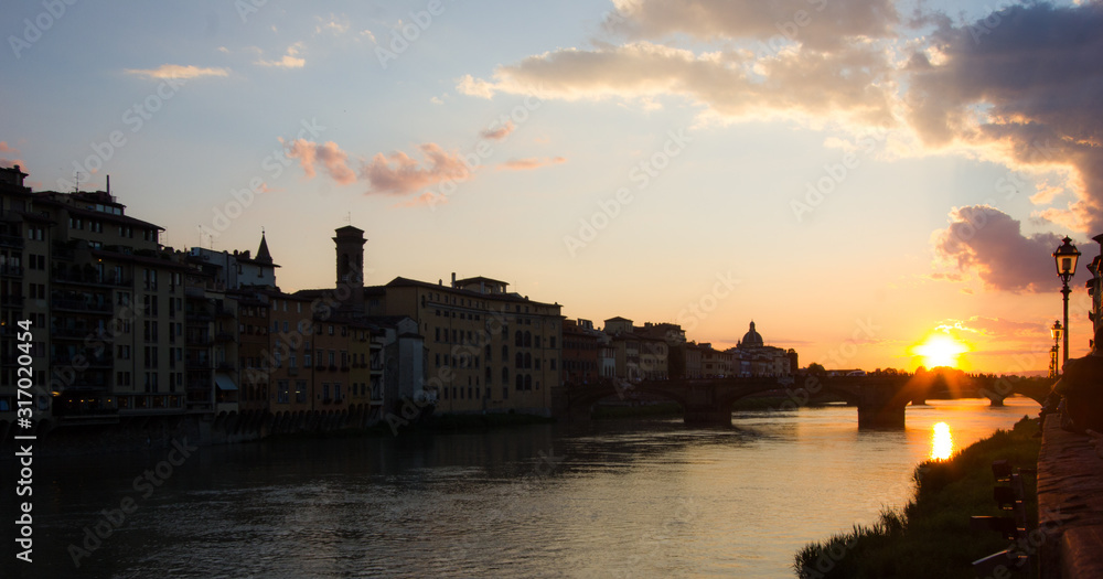 sunset over town and river