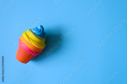 anti stress squishy toy in the form of multicolored ice cream on blue background photo