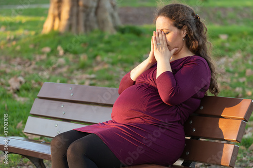 Fotografie Young pregnant woman taking a moment to de-stress