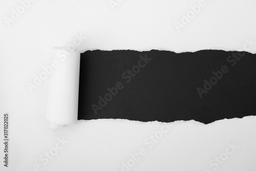 torn white paper frame on black backdrop