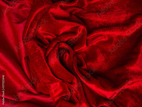 deep red velvet texture for background, red rose shape, love and passion concept. very affectionate and passionate. Soft fabric shaped as female genital organs, labia photo