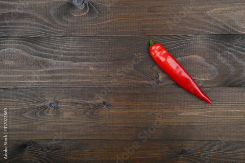 red chili pepper on wooden background with copy space