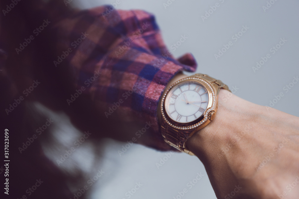 looking at luxury watch on hand check the time at workplace.concept for managing time organization working,punctuality,appointment.fashionable wearing stylish looking at luxury watch on hand check the time at workplace.concept for managing time organization working,punctuality,appointment.fashionable wearing stylish