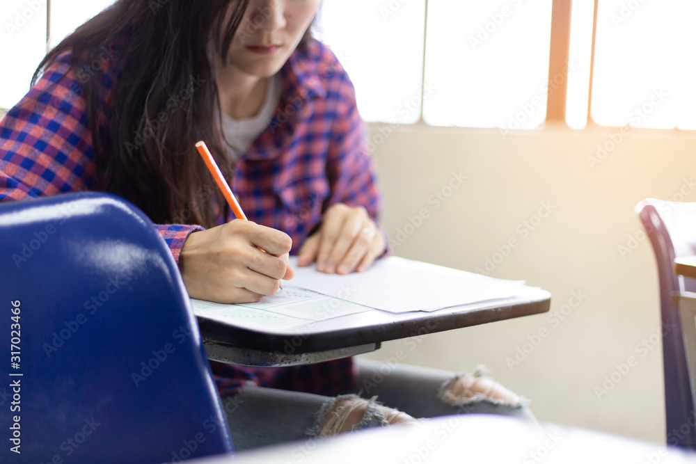 high school,university student study.hands holding pencil writing paper answer sheet.sitting lecture chair taking final exam attending in examination classroom.concept scholarship for education abroad high school,university student study.hands holding pencil writing paper answer sheet.sitting lecture chair taking final exam attending in examination classroom.concept scholarship for education abroad