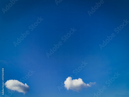 Two Beautiful small white clouds on blue sky