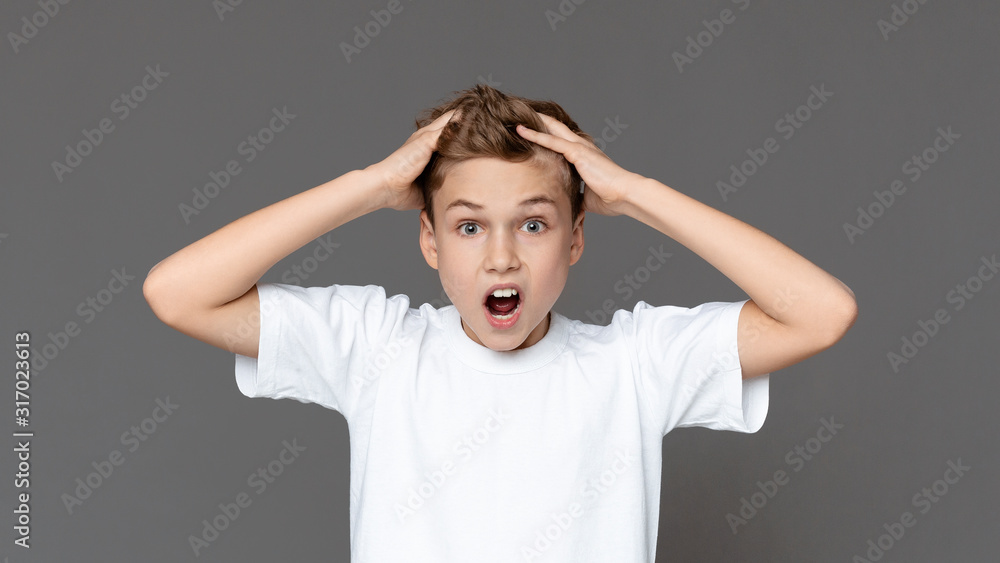 Emotional teen boy screaming and grabbing hair in panic Emotional teen boy screaming and grabbing hair in panic
