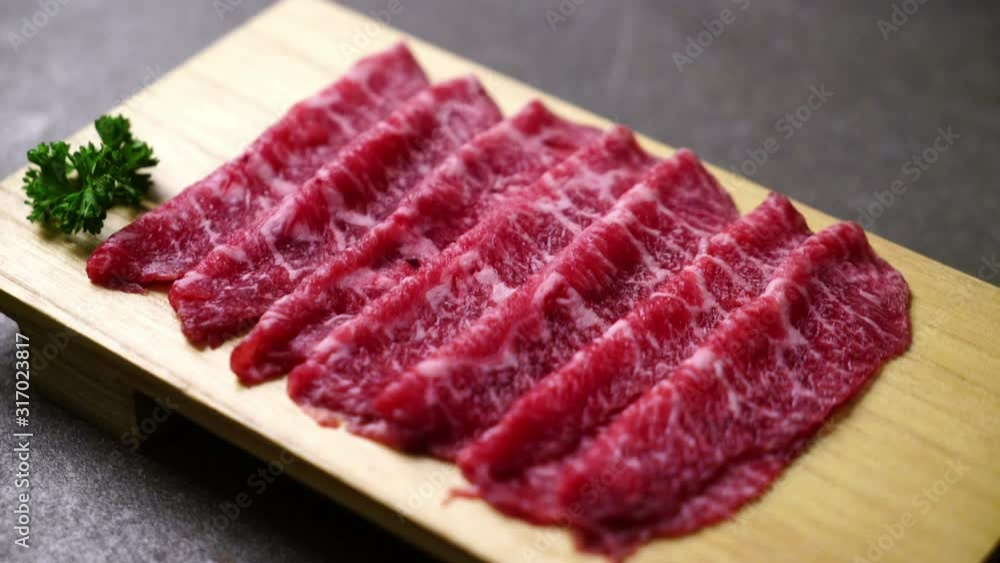 fresh beef raw sliced with marbled texture served for Sukiyaki and Shabu or Yakiniku fresh beef raw sliced with marbled texture served for Sukiyaki and Shabu or Yakiniku
