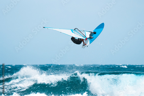 windsurf jumps out of the water