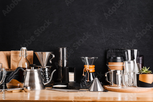 Accessories and utensils for making coffee drinks on a wooden table, coffee shop interior photo