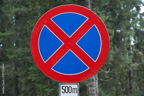 The road sign "Stopping prohibited" prohibits the stopping and parking of vehicles. Road rules, Traffic code.