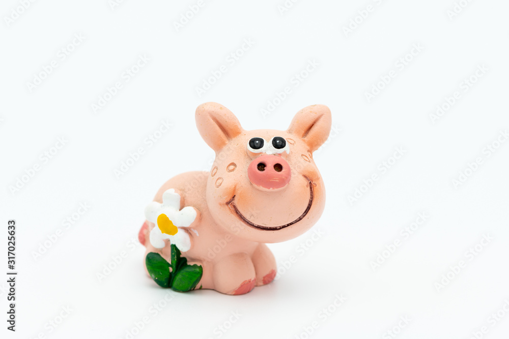Figurine of a small piggy with a white flower Figurine of a small piggy with a white flower