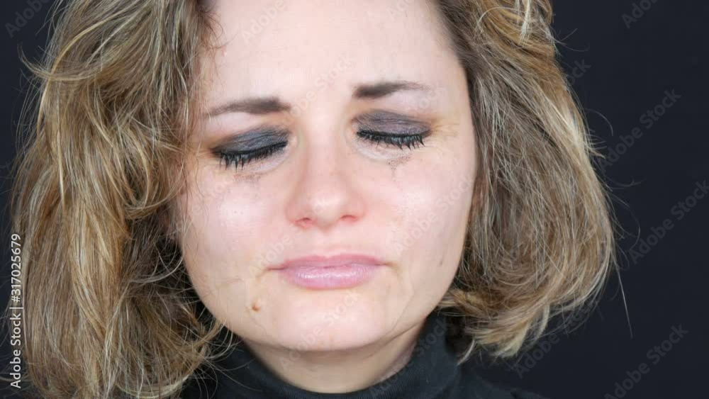 Depressive sad tearful girl woman with smeared makeup and lipstick on her face sadly looking at the camera with a crying suffering Depressive sad tearful girl woman with smeared makeup and lipstick on her face sadly looking at the camera with a crying suffering
