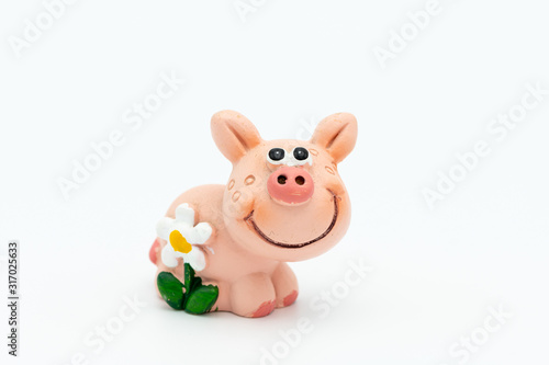 Figurine of a small piggy with a white flower
