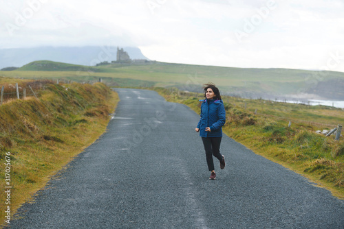 sporty woman running on road