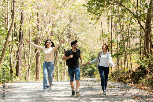 Group backpack people travel and explore adventure in nature. Asian friends and team walking relax for destination leisure landscape forest in summer day. Travel and lifestyle Concept.