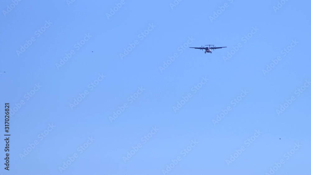 airplane in clear blue sky is landing. releasing the chassis. copy space airplane in clear blue sky is landing. releasing the chassis. copy space