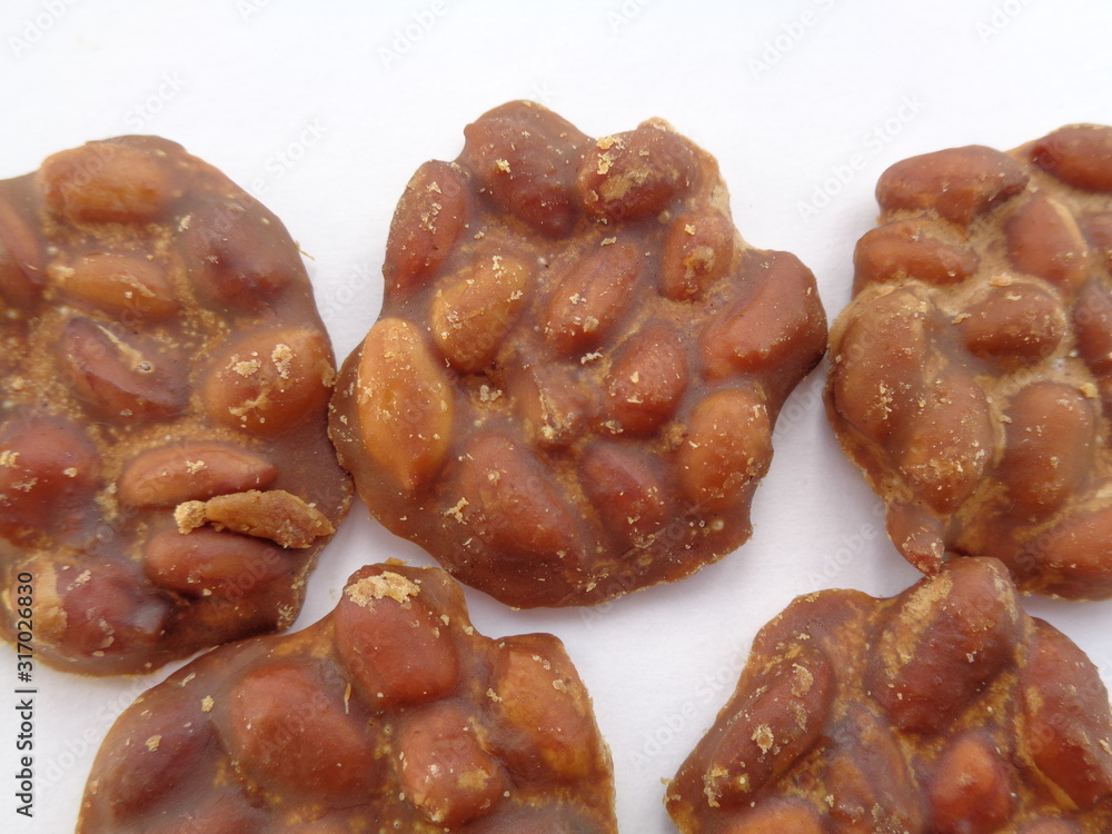 enting enting on the white background. indonessian traditional snack made of caramelize palm sugar and peanut enting enting on the white background. indonessian traditional snack made of caramelize palm sugar and peanut