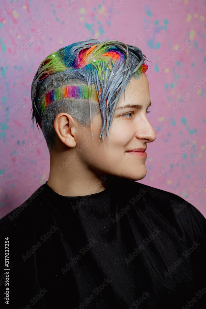 Hairdresser colorist dyes the hair of a woman to a client in different