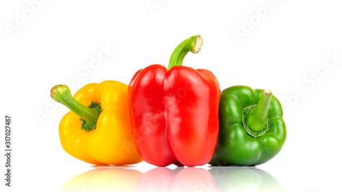 Fotografie Fresh vegetables Three sweet Red, Yellow, Green Peppers isolated on white background