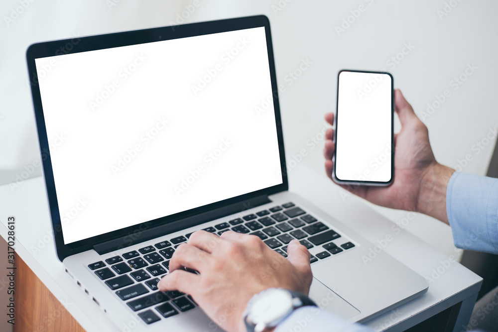 mockup image blank screen computer,cell phone with white background for advertising text,hand woman using laptop texting mobile contact business search information on desk in cafe.marketing,design mockup image blank screen computer,cell phone with white background for advertising text,hand woman using laptop texting mobile contact business search information on desk in cafe.marketing,design