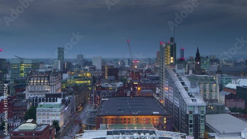 manchester city center aerial panoramic view time lapse from night to day  england uk zoom out photo