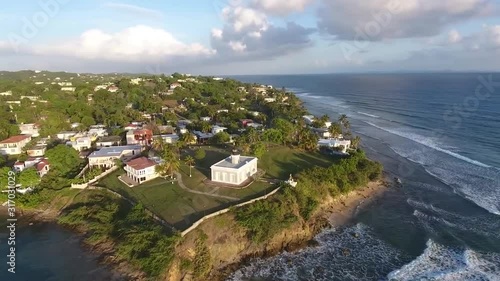 Wallpaper Mural The Stunning Scenery Of Unique Houses and Green Trees Surrounded By Blue Calm Ocean In Puerto Rico - Aerial Shot Torontodigital.ca