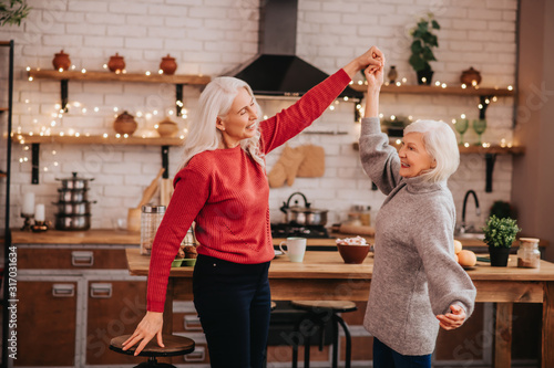 Schilderij op canvas Two mature grey-haired positive ladies having fun