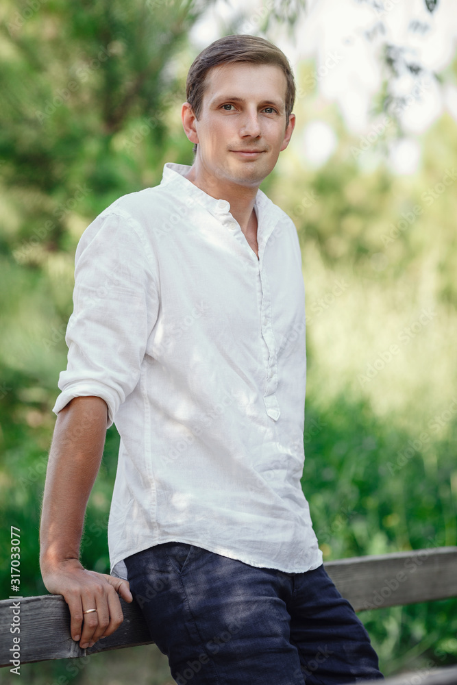 young courageous man in the summer garden. young courageous man in the summer garden.