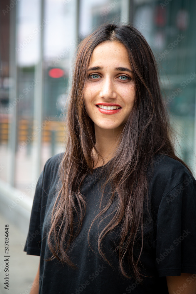 Fototapeta premium Beautiful Olive Skinned Young Woman With Light Colored Eyes