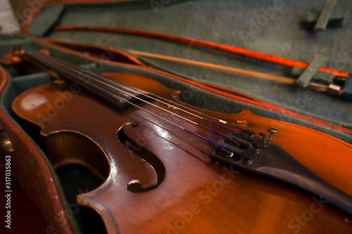 Old violin and bow in a case.