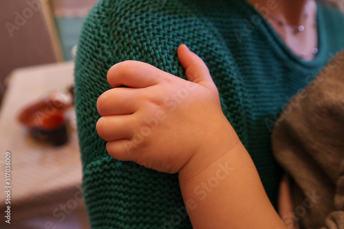 Children's hands. The child holds his mom. Children's fist.